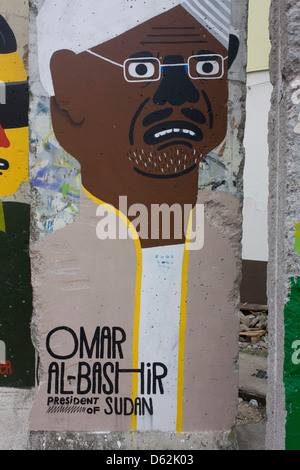 Ein Bild des sudanesischen Präsidenten Omar al-Bashir ziert ein alten Teil der alten Mauer gegenüber dem ehemaligen Checkpoint Charlie, die ehemalige Grenze zwischen Ost und West Berlin während des Kalten Krieges. Die Berliner Mauer war eine Barriere, die von der Deutschen Demokratischen Republik (DDR, Ostdeutschland) ab dem 13. August 1961, gebaut, die völlig abgeschnitten (Landweg) West-Berliner aus den umliegenden Ostdeutschland und aus Ostberlin. .. (Mehr in Beschreibung). Stockfoto