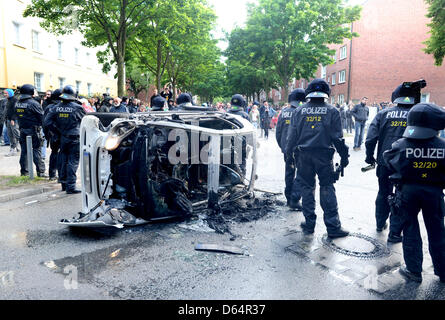 Polizisten klar Bereich Barrikaden und brennende Autos während einer Neonazi-Kundgebung unter dem Motto "Tag der deutschen Zukunft" in Hamburg, Deutschland, 2. Juni 2012. Mehrere tausend Menschen demonstrierten gegen den Marsch der Rechtsextremisten. Foto: Christian Charisius Stockfoto