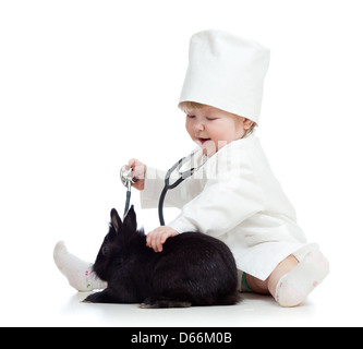 Liebenswert Kind mit Kleidung des Arztes. Mädchen spielt mit Haustier Hase Stockfoto