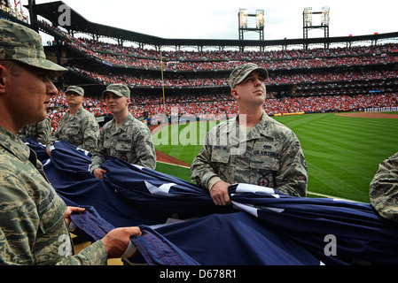 Personal Sgt. Christopher Johnston, 375. Zivilingenieurgeschwader von der Scott Air Force Base, Abb., nimmt die Szene im Busch Stadium, dem Heimstadion der St. Louis Cardinals, als er und seine Mitstreiter die Riesenfahne für fast 50,000 Fans präsentieren, um den 8. April 2013 zu sehen. Scott AFB war an zahlreichen Sportveranstaltungen beteiligt, aber dies war das erste Mal, dass sie die Flagge am Eröffnungstag der Saison präsentierten. Die Kardinäle gingen weiter zu verlieren, um die Cincinnati Reds 13-4. (USA Air Force Foto/Staff Sgt. Ryan Crane) Stockfoto