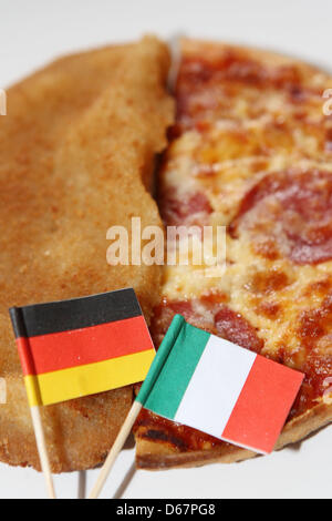 ILLUSTRATION - eine illustrierte Bild zeigt ein Schnitzel mit deutscher Flagge und eine Pizza mit einer italienischen Flagge auf einem Teller in Hamburg, Germany, 26. Juni 2012. Deutschland spielen Italien im Halbfinale der EURO 2012 in Warschau am 28. Juni 2012. Foto: Malte Christen Stockfoto