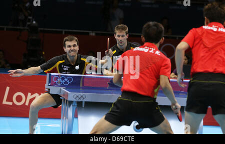 Timo Boll (L) und Bastian Steger (C/zurück) in Aktion in Aktion während des Spiels gegen Jike Zhang (C/Front) und Hao Wang (R) von China während Herren Team Halbfinale des Tischtennis-Events in ExCeL Arena auf die 2012 Olympischen Spiele in London, London, Vereinigtes Königreich, 6. August 2012 Deutschlands. Foto: Christian Charisius dpa Stockfoto