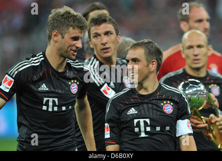 Münchens Thomas Mueller (L-R), Mario Mandzukic, Philipp Lahm und Arjen Robben feiern den 2: 1-Sieg in der DFL-Supercup-Spiel zwischen FC Bayern München und Borussia Dortmund in der Allianz Arena in München, Deutschland, 12. August 2012. Foto: ANDREAS GEBERT Stockfoto