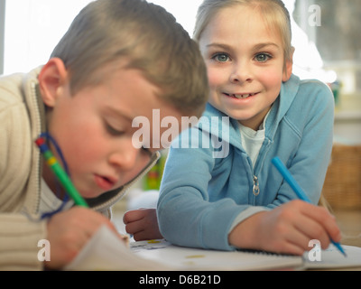 Kinder zeichnen zusammen auf Boden Stockfoto