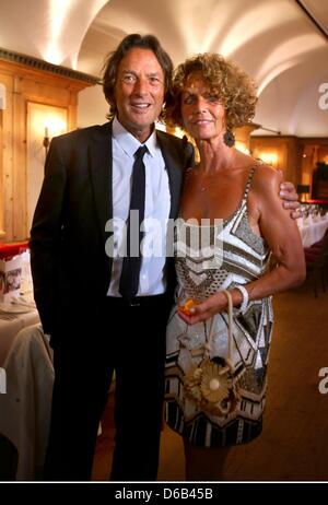 Promi-Arzt stellt Dr. Hans-Wilhelm Müller-Wohlfahrt für Bilder mit seiner Frau Karin während seines 70. Geburtstags-Party am Seehaus in München, Deutschland, 16. August 2012. Dr. Mueller Wohlfahrt ist unter anderem der Club Arzt des Fußball-Bundesligisten FC Bayern München. Foto: Alexander man Stockfoto