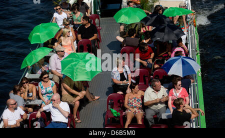 Touristen genießen den Sonnenschein und sommerlichen Temperaturen auf einem Boot fahren auf der Spree in Berlin, Deutschland, 19. August 2012. Foto: Kay Nietfeld Stockfoto