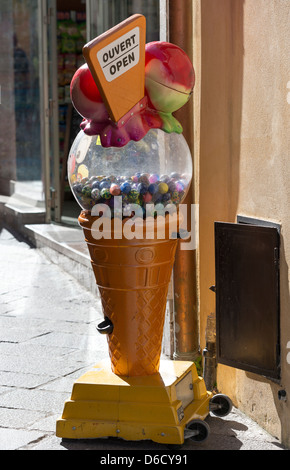 Ein Kaugummi-Spender in der Form einer riesigen Eistüte Werbung eine Gelaterio in Taormina, Italien Stockfoto