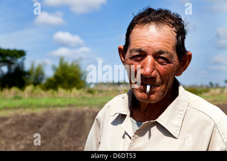 Landwirtschaft, Landwirt, Bauer, Menschen und kubanischen Mann im Hof. ANAP Genossenschaft in Guines, Kuba. Mann Rauchen mit einem Lächeln, Porträt