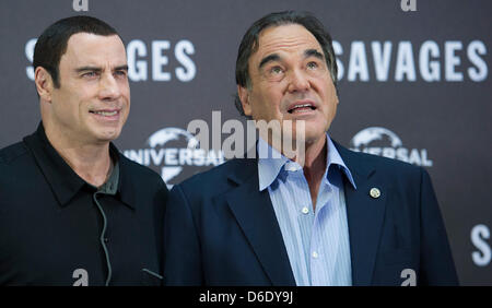 US-amerikanischer Schauspieler John Travolta (L) posiert für Fotos mit dem amerikanischen Regisseur Oliver Stone während der Präsentation von Herrn Stein neuer Film "Wilden" in Berlin, Deutschland, 17. September 2012. Der Film Premieren am 11. Oktober 2012 in den deutschen Kinos. Foto: HANNIBAL HANSCHKE Stockfoto