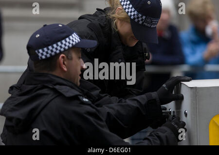 London, UK. 17. April 2013. Polizisten suchen die Straße vor der Beerdigung von Margaret Thatcher. Im Anschluß-Markierungsfahne drapiert und auf einer Lafette montiert, bewegt sich der Sarg des ehemaligen britischen Premierministers Baronin Margaret Thatcher Sarg entlang Fleet Street in Richtung St. Pauls Kathedrale in London, England. Gewährt einem feierlichen Begräbnis mit militärischen Ehren, nicht gesehen, seit dem Tod von Winston Churchill im Jahre 1965, erwarten Familie und 2.000 VIP-Gäste (inkl. Queen Elizabeth) ihr Gefolge. Bildnachweis: Richard Baker/Alamy Live-Nachrichten Stockfoto