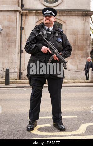 London Aldwych Strand Baroness Margaret Thatcher Beerdigung big tall Bärtigen bewaffneten Polizisten in Uniform mit Maschinengewehr Stockfoto