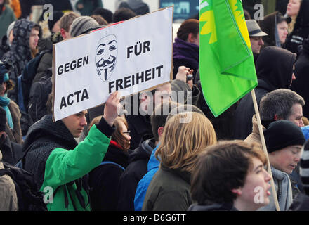 Gegen Acta denn Freiheit steht auf einem Schild gehalten von einem jungen Mann während einer Demonstration in Berlin, Deutschland, 11. Februar 2012 geschrieben. Der Protest ist gegen das Anti-Counterfeiting Trade Agreement (Acta). ACTA ist gedacht zur Durchsetzung der Rechte am geistigen Eigentum online. Nach Polizeiberichten protestierten etwa 2.000 Menschen in der Nähe von Rathaus in Berlin. Foto: SOEREN STACHE Stockfoto