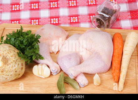 drei Hähnchenschenkel und Gemüse auf Hintergrund Stockfoto