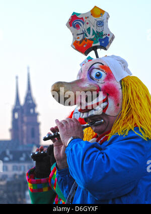 Narren schlendern durch die Strassen während des sogenannten Morgen Streiks ("Morgenstraich") in Basel, Schweiz, 27. Februar 2012. Die traditionelle Basler Fasnacht startete mit dem Morgen Streik am Montag nach Aschermittwoch, wenn alle Straßenlaternen in der Stadt alle bei 04:00 ausgeschaltet sind. Für 72 Stunden wird die Luft erfüllt vom Lärm der Pfeifen und Trommeln aus Marschmusik, Stockfoto