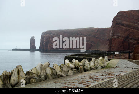 Wellenbrecher, Hochwasserschutz Wehrmauern und die Rock-Spalte, die "Lange Anna" auf die einzige deutsche Hochsee Inseln Helgoland, Deutschland, 2. März 2012 abgebildet sind. "Lange Anna" ist Deutschlands nur freistehende Meer Stack und Wahrzeichen von Helgoland. Foto: CHRISTIAN CHARISIUS Stockfoto