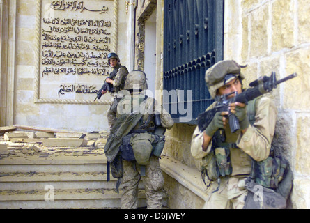 US Marines verdecken gegenseitig bei ihrer Vorbereitung auf einen der Paläste von Saddam Husseins geben während der Operation Iraqi Freedom 9. April 2003 in Bagdad, Irak. Stockfoto