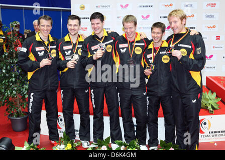 Deutschlands Trainer Joerg Rosskopf (L-R) und Spieler Timo Boll, Dimitrij Ovtcharov, Bastian Steger und Patrick Baum, Christian Suess ihre Silbermedaille bei Team Tischtennis Weltmeisterschaften 2012 in Westfalenhalle in Dortmund, Deutschland, 1. April 2012 feiern. Foto: Friso Gentsch Stockfoto