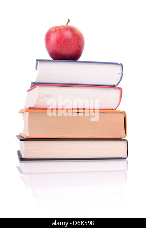 ein roter Apfel in Büchern isoliert auf weiss Stockfoto