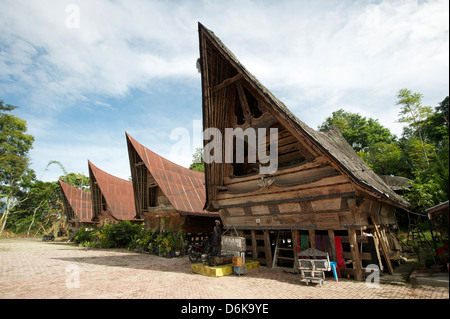 Batak Toba Dorfhäuser mit Hochdach beendet und Stammes-Schnitzereien, Tomuk, Samosir Island, Sumatra, Indonesien, Südostasien Stockfoto