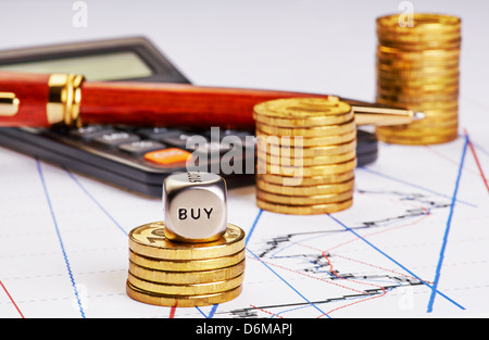 Aufwärtstrend Münzen stapeln, Taschenrechner, Stift und Würfel Cube mit dem Wort kaufen auf finanzielle Diagramm. Selektiven Fokus Stockfoto