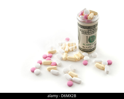Bunte Pillen in einer Flasche gemacht Geld auf weißem Hintergrund. Stockfoto