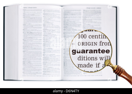 Vergrößert eine Lupe über ein Wörterbuch das Wort Garantie betrachten gehalten Stockfoto