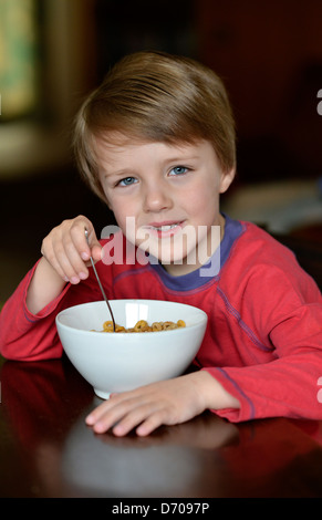 Ein Junge im Alter von fünf Jahren eine Schüssel Müsli zu essen. Stockfoto