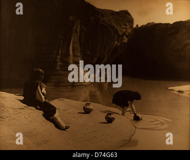 Dieses Foto von Edward Sheriff Curtis zeigt Indianer im Old Well in Acoma und hält einen Moment von kultureller Bedeutung fest. Curtis ist bekannt für seine Porträts des Lebens der Ureinwohner Amerikas, die einen Einblick in die Traditionen der Ureinwohner bieten. Stockfoto