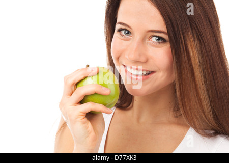 Hübsche junge Frau, die einen grünen Apfel, isoliert auf weiss Essen Stockfoto