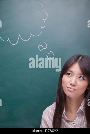 Junge Frau mit Sprechblase auf Tafel Stockfoto