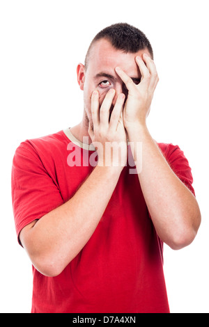 Deprimiert Mann, der sein Gesicht, isoliert auf weißem Hintergrund Stockfoto