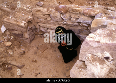 Beduinenfrau aus dem Stamm der Zawaideh, die in den Wüsten des südlichen Jordaniens und des westlichen Saudi-Arabiens beheimatet ist und traditionelles Madraga-Gewand in der Wadi Rum-Wüste Jordaniens trägt Stockfoto