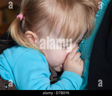Müdes Kind schlief in seinen Armen Mütter Stockfoto