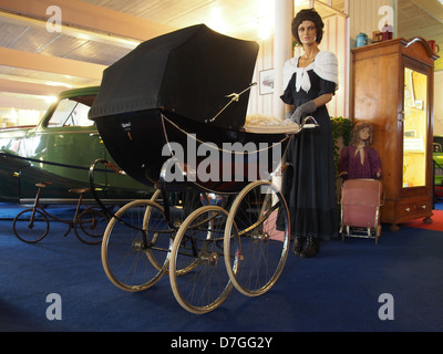 Dieses historische Bild zeigt einen Kinderwagen oder Kinderwagen, ein Schlüsselbeispiel für Kindertransporte im frühen 20. Jahrhundert, das das Design und die gesellschaftlichen Vorlieben dieser Zeit widerspiegelt. Stockfoto