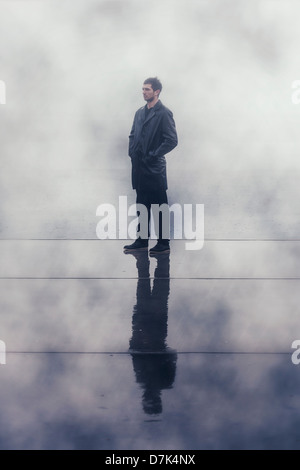 ein finsterer Mann in einer schwarzen nass Lederjacke bei Regen Stockfoto