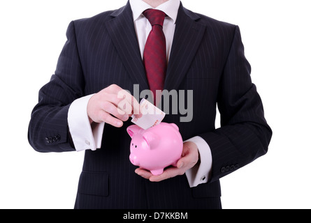 Geschäftsmann, ein 10-Euro-Schein in ein Sparschwein, Konzept des Sparens isoliert auf weiss Stockfoto