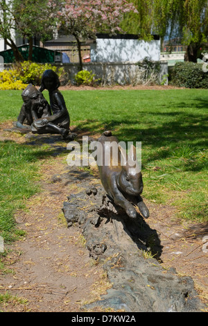 Die Skulptur "Alice und das weiße Kaninchen" von Künstler Edwin Russell. Guildford, Surrey. Stockfoto