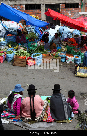 Aymara-Frauen oder Cholitas sitzen in Straßen- und Gemüseständen im Mercado Rodriguez, einem typischen Straßenmarkt in der Nähe des Stadtzentrums, La Paz, Bolivien Stockfoto