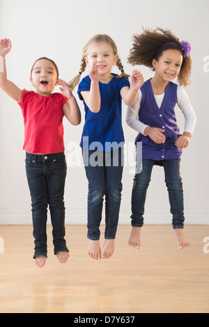 Mädchen springen vor Freude zusammen Stockfoto