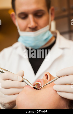 Kaukasische Zahnarzt untersucht die Zähne Frau im Büro Stockfoto