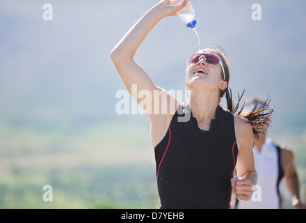 Läufer sprühen Wasser in Rennen Stockfoto