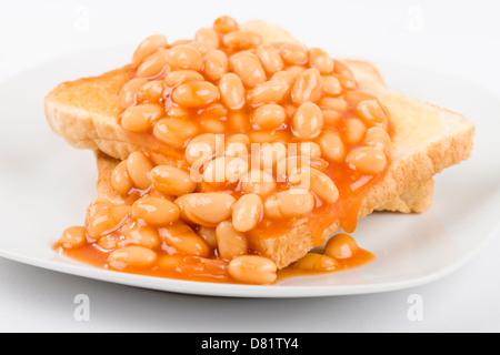 Bohnen auf Toast - Scheiben geröstetes Weißbrot mit Butter und garniert mit gebackenen Bohnen. Einfache britische Frühstück Essen. Stockfoto