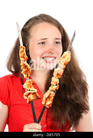 Das Mädchen blickte mit hungrigen Blick auf Spieße. Isolierung auf weiß Stockfoto