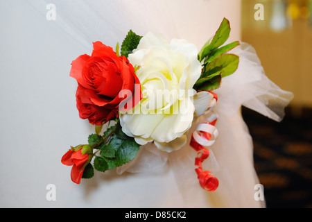 Rote und weiße Blüten schmücken die Kirche am Tag der Hochzeit Stockfoto