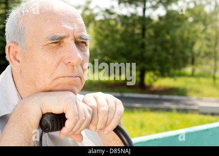 Senior Glatzkopf Blick auf etwas in einem park Stockfoto