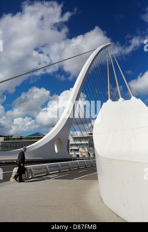 Ein Fußgänger überquert die Samuel Beckett Bridge, die den Fluss Liffey überspannt verbinden Sir John Rogerson Quay mit Nordwand Stockfoto