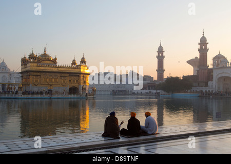 Amritsar Punjab, Indien. Goldene Tempel, drei Sikh Anhänger bei Sonnenaufgang Stockfoto