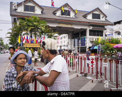 23. Mai 2013 - Mae Sot, Tak, Thailand - Burma warten vor der Brücke der Freundschaft zwischen Mae Sot, Thailand und Myawaddy, Myanmar, für den Tag zu öffnen, so dass sie zurück nach Birma laufen können. Fünfzig Jahre der politischen Unruhen in Burma (Myanmar) hat Millionen von Burmesen ihr Land verlassen geführt. Viele haben im benachbarten Thailand niedergelassen. Mae Sot, an der Mae Nam Moie (Moie River) ist das Zentrum der birmanischen Exil lebende Gemeinschaft im zentralen Westen Thailands. Es gibt Hunderte von Tausenden von burmesischen Flüchtlingen und Migranten im Bereich. Viele Leben ein Schattendasein ohne Papiere und ohne Rückgriff, wenn th Stockfoto