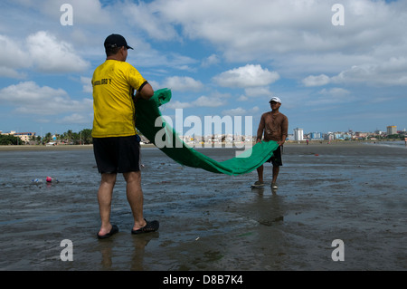 Zwei Männer aus Manabi wicklung ein Fischernetz am Strand Tarqui Stockfoto