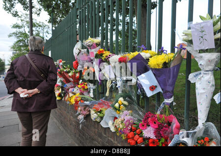 Woolwich, London, UK. 23. Mai 2013. Eine Frau liest Karten mit Botschaften der Anteilnahme an der Stelle des Mordes. Blumen sind von Gratulanten entlang der Geländer in der Nähe der Stelle links wo Schlagzeuger Lee Rigby des 2. Bataillons der Royal Regiment of Fusiliers wurde außen Woolwich Barracks gestern getötet. Bildnachweis: Matthew Chattle/Alamy Live-Nachrichten Stockfoto